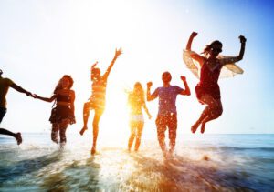 Friends splashing and jumping in the water during spring break in Key West